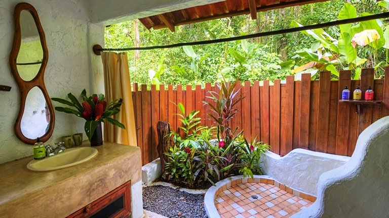 Private open-air garden bathrooms at Nicuesa Lodge exemplify the hotel's harmony with nature philosophy